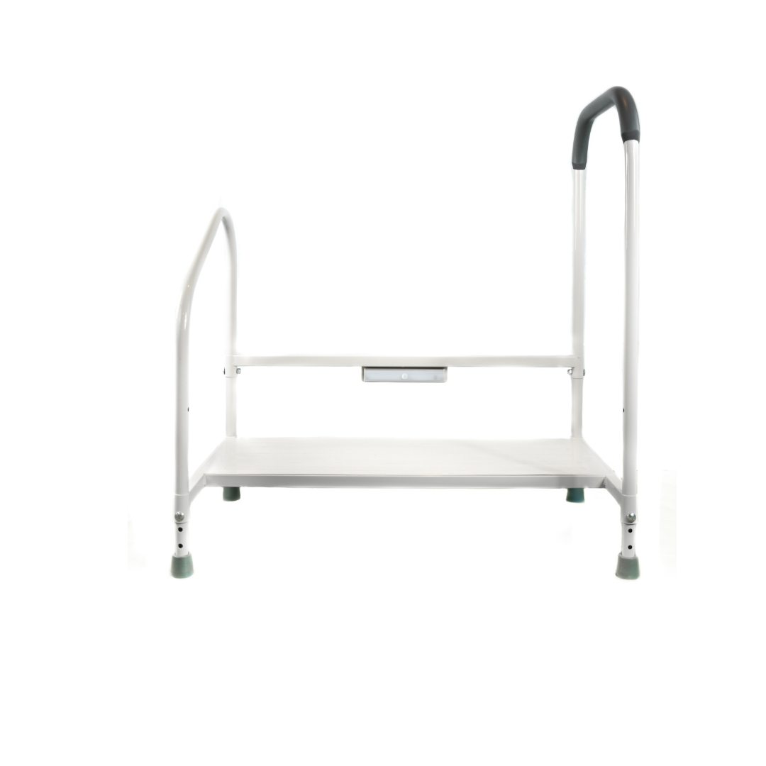 The Step2Bed Bedside Stepper with Fall Prevention Handles is a white metal step stool with two handrails, a rubber-topped handle, non-slip feet, and a single step platform for stable, safe bedside access.